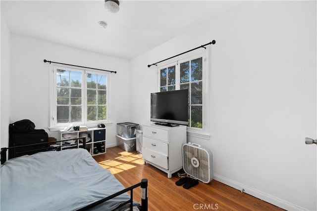 bedroom featuring baseboards and light wood-style floors