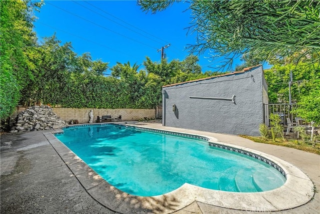 view of swimming pool with a patio area, a fenced backyard, and a fenced in pool