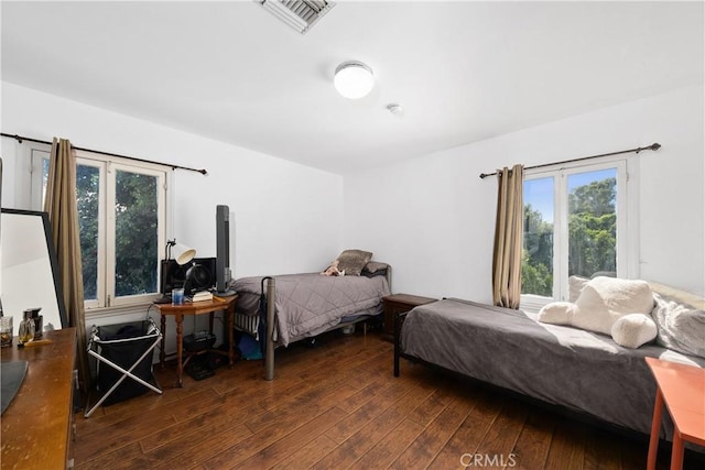 bedroom featuring dark wood-type flooring and visible vents