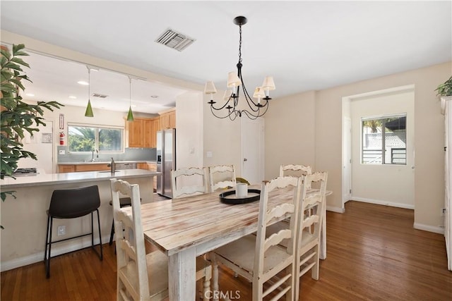 dining space with recessed lighting, visible vents, an inviting chandelier, wood finished floors, and baseboards