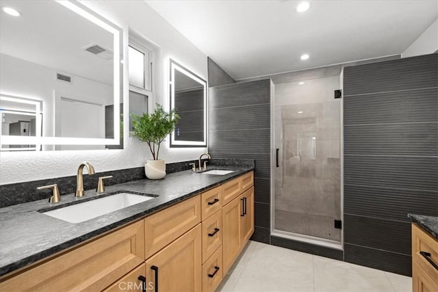 bathroom featuring vanity, tile patterned floors, and a shower with door