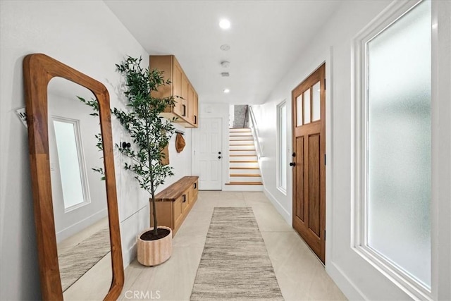 corridor featuring light tile patterned floors