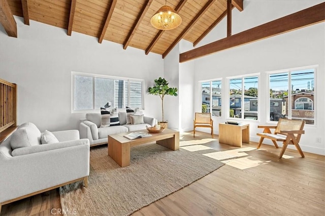 living room featuring wood ceiling, a healthy amount of sunlight, light wood-type flooring, and a notable chandelier