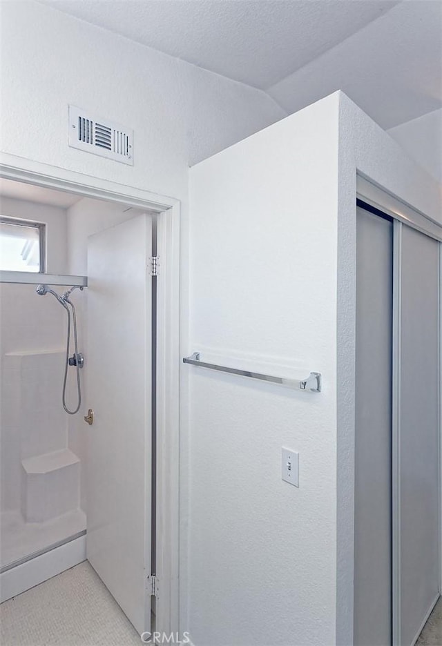 bathroom featuring walk in shower