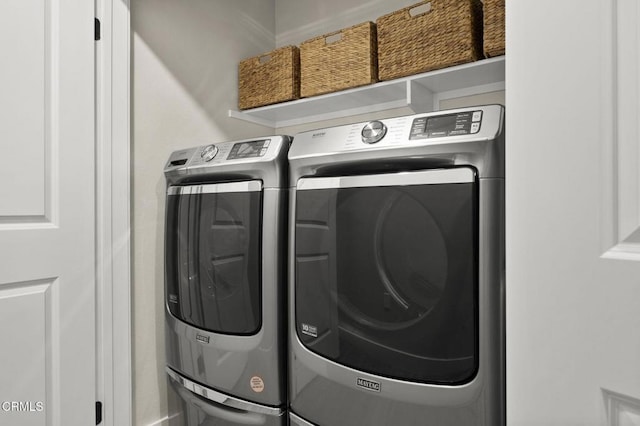 clothes washing area featuring separate washer and dryer