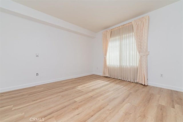 unfurnished room with light hardwood / wood-style flooring