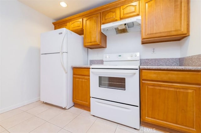 kitchen with white appliances and light tile patterned floors