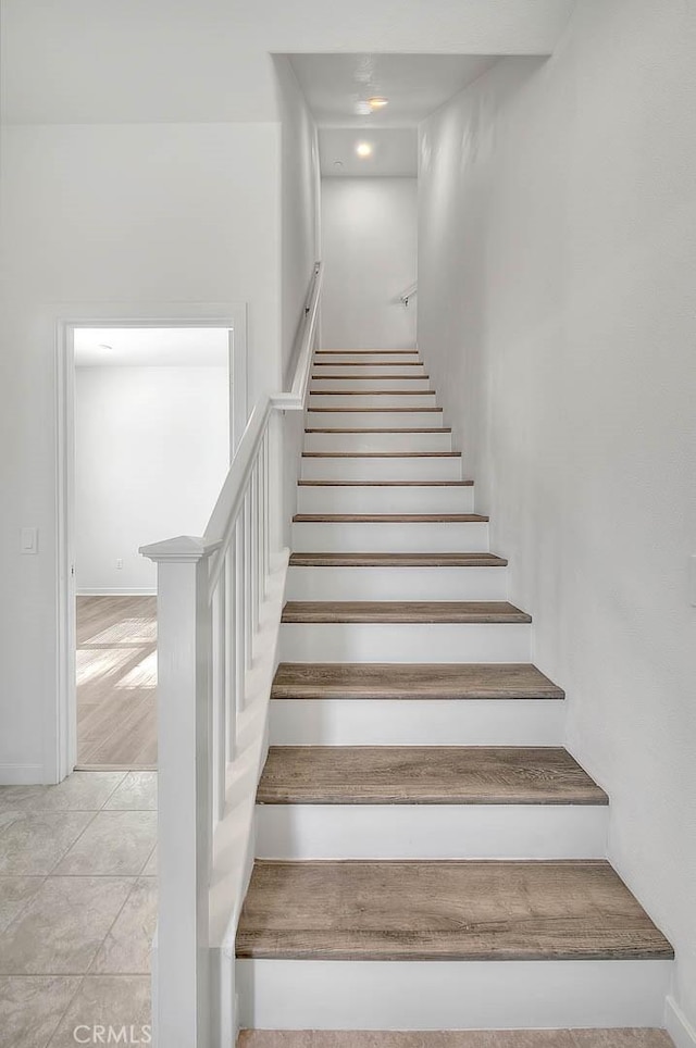 stairs with tile patterned flooring