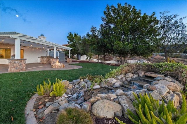 view of yard with a patio area, fence, and a pergola