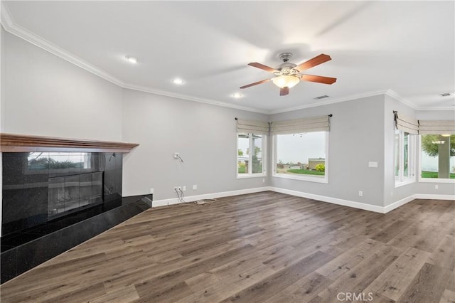 unfurnished living room with crown molding, wood finished floors, visible vents, and baseboards