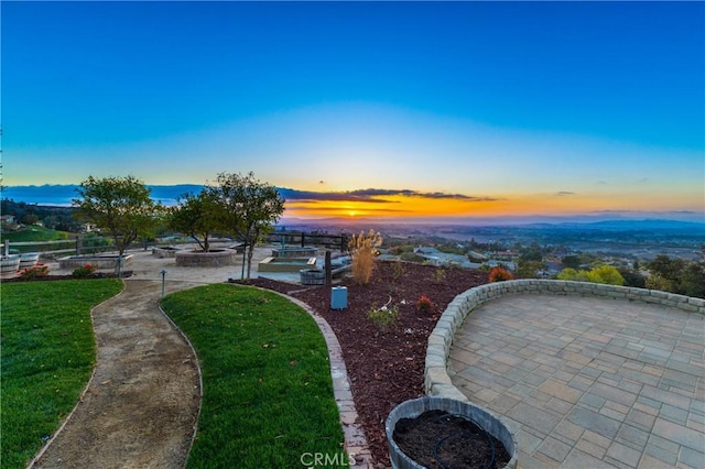 surrounding community with a lawn and a patio