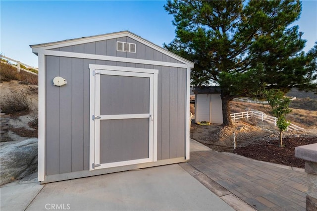 view of shed with fence