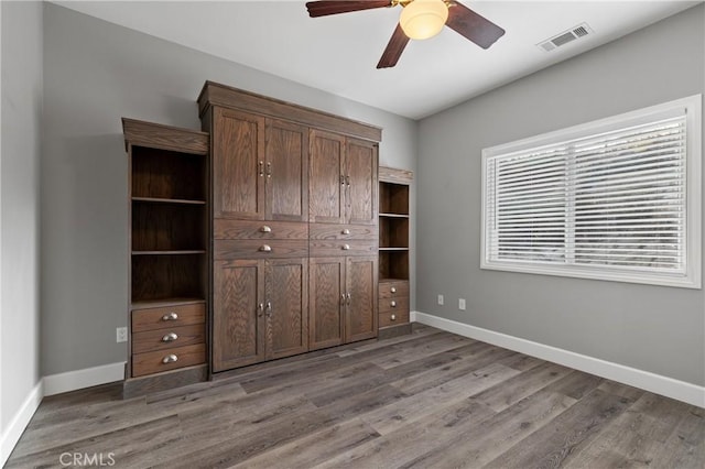 unfurnished bedroom with light wood-type flooring, visible vents, and baseboards