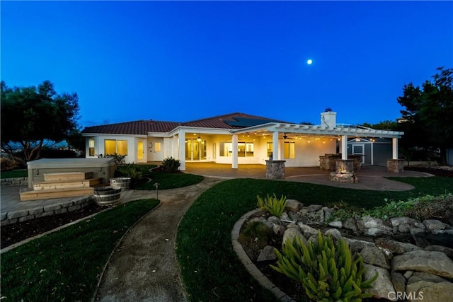 back of house featuring a patio, stucco siding, solar panels, a hot tub, and ceiling fan