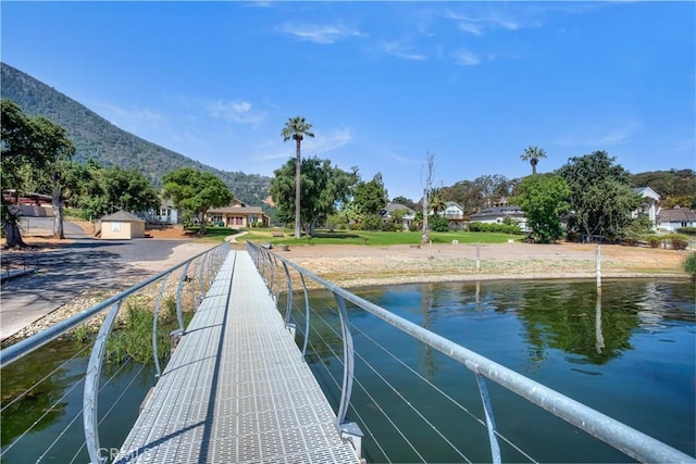 view of dock featuring a water and mountain view