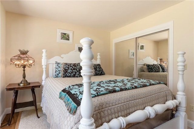 bedroom featuring baseboards and a closet