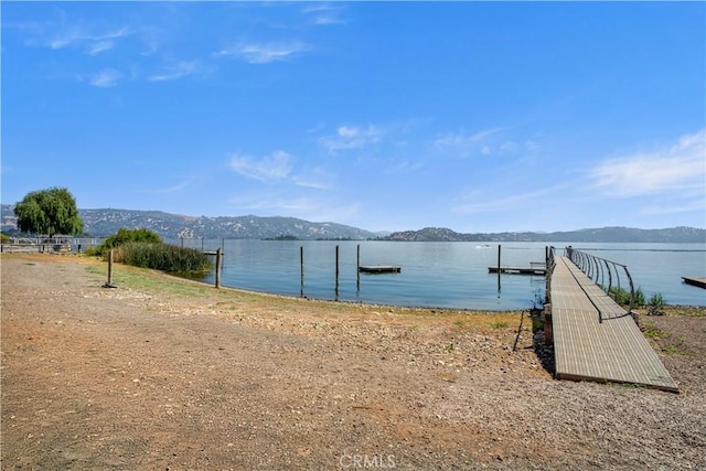 dock area featuring a water and mountain view