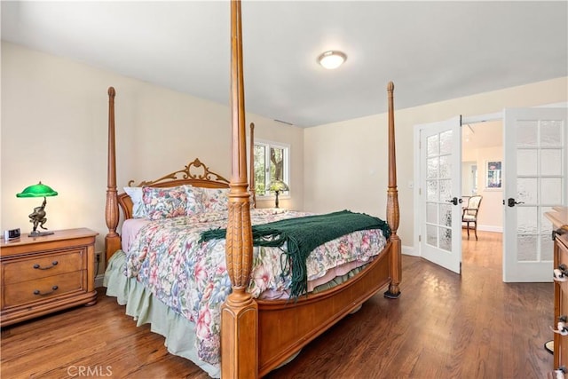 bedroom featuring french doors, baseboards, and dark wood-style flooring