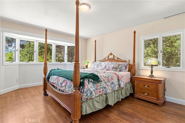 bedroom with baseboards and wood finished floors