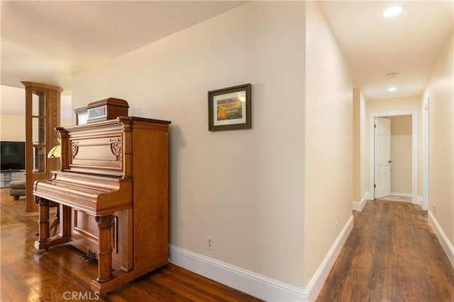 corridor with baseboards, dark wood-type flooring, and recessed lighting