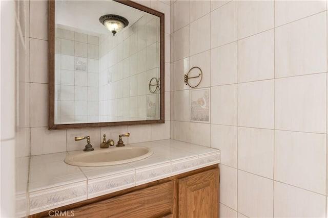 bathroom with tile walls and vanity