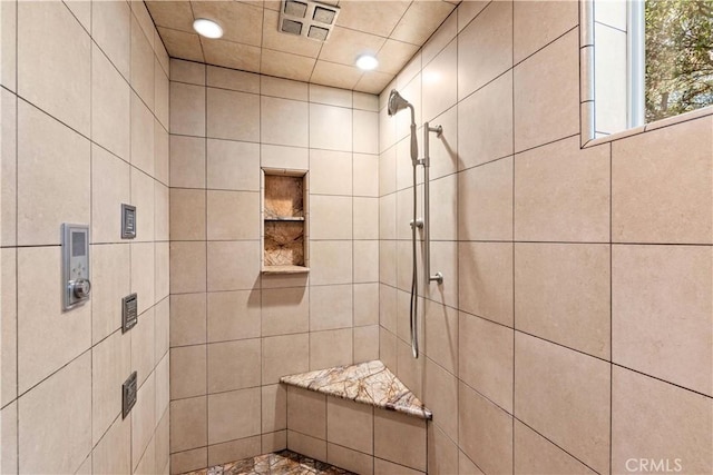 bathroom featuring tiled shower and recessed lighting