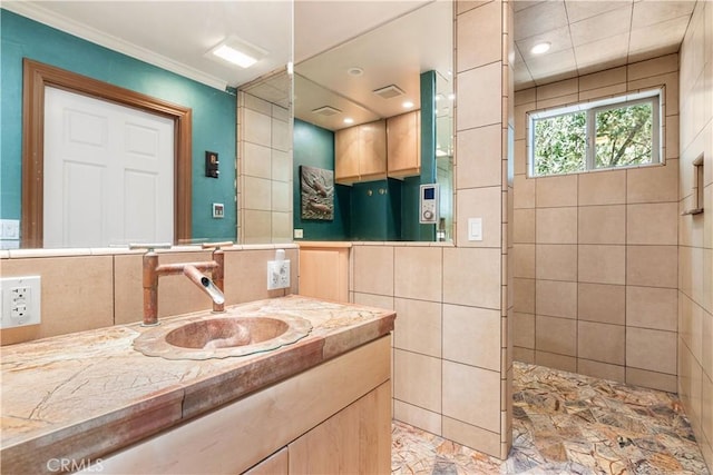 bathroom featuring visible vents, a walk in shower, tile walls, and vanity