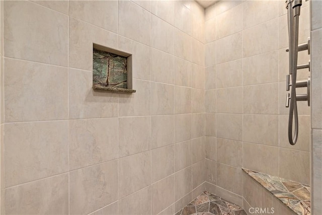 bathroom with a tile shower