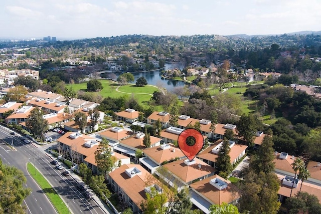 drone / aerial view featuring a residential view and a water view