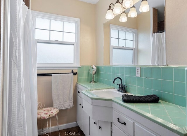 bathroom with vanity and tasteful backsplash