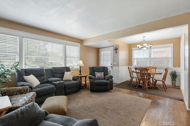 living room featuring dark hardwood / wood-style floors and an inviting chandelier