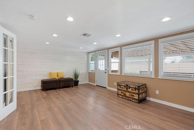 entryway with french doors and light hardwood / wood-style floors