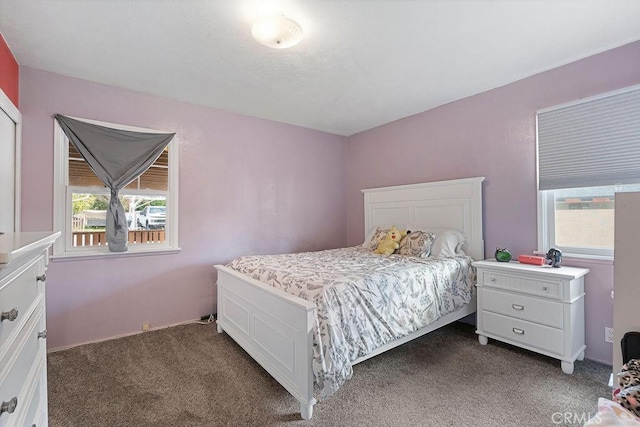 carpeted bedroom with multiple windows