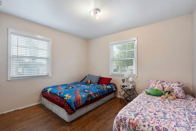 bedroom with dark hardwood / wood-style floors