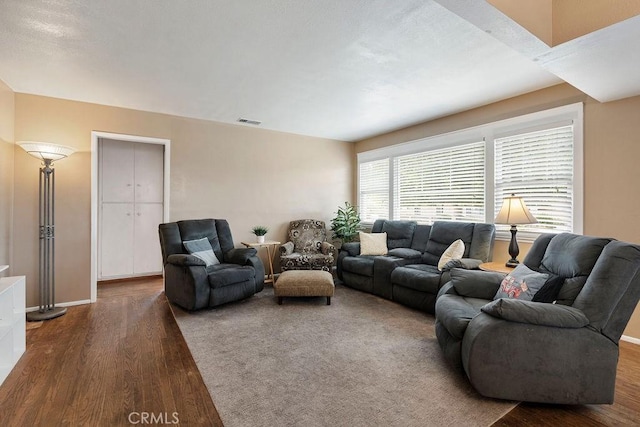 living room with dark hardwood / wood-style flooring