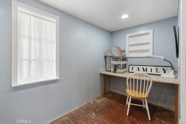 office area featuring plenty of natural light and built in shelves