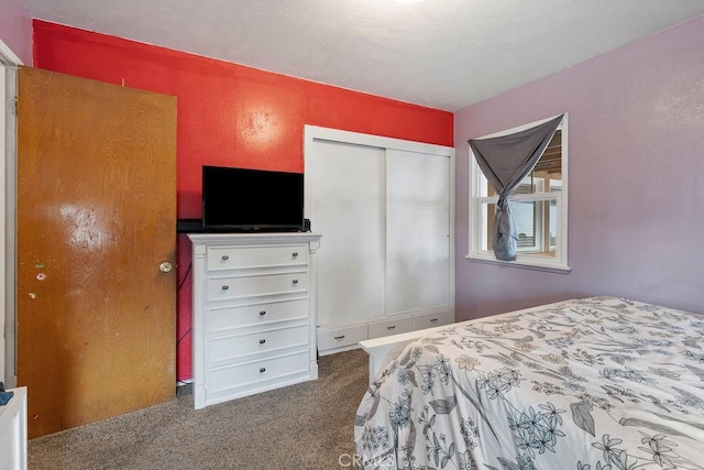 carpeted bedroom featuring a closet