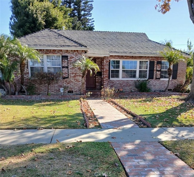 bungalow-style home featuring a front yard