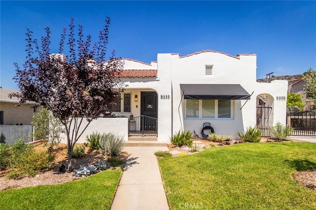 mediterranean / spanish-style home featuring a front yard