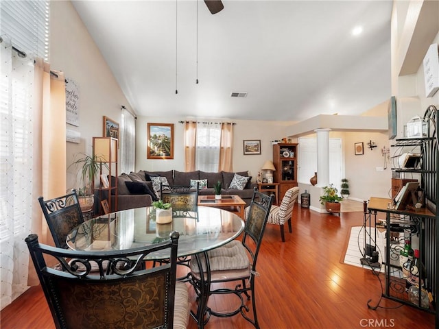 dining room featuring ornate columns, lofted ceiling, hardwood / wood-style floors, and ceiling fan