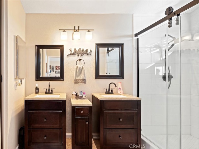 bathroom with vanity and a shower with shower door