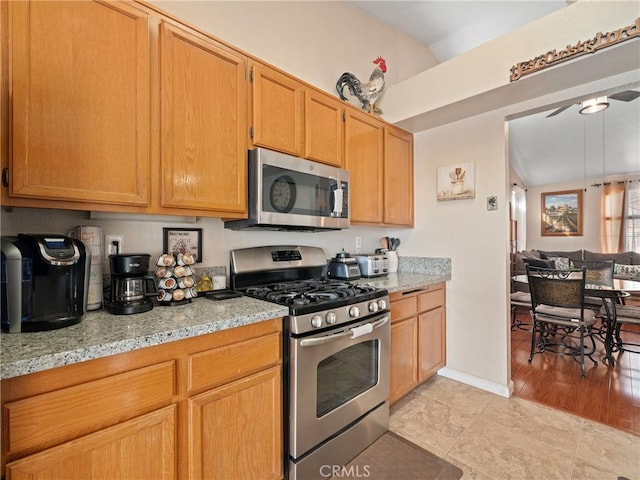 kitchen featuring light stone counters and appliances with stainless steel finishes