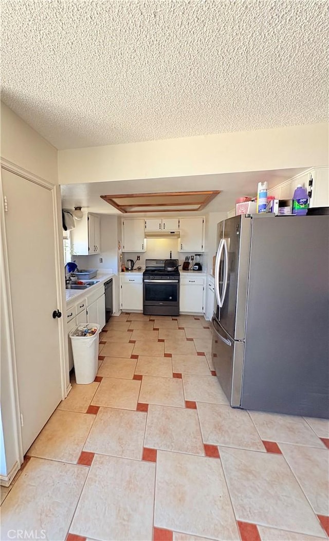 washroom featuring sink, hookup for a washing machine, a textured ceiling, and light tile patterned floors