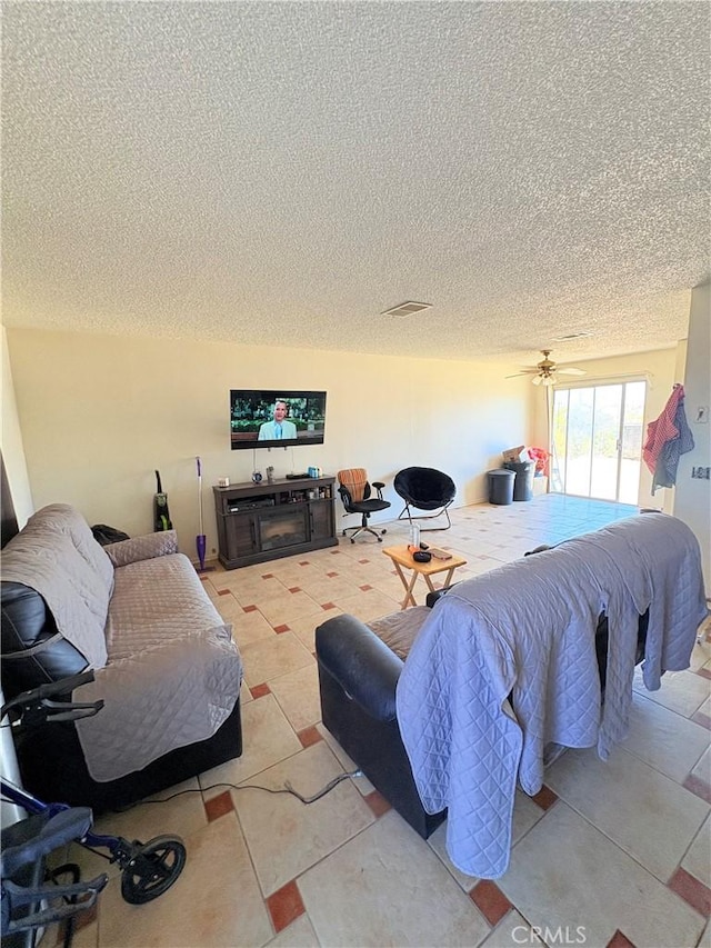 bedroom featuring access to outside and a textured ceiling