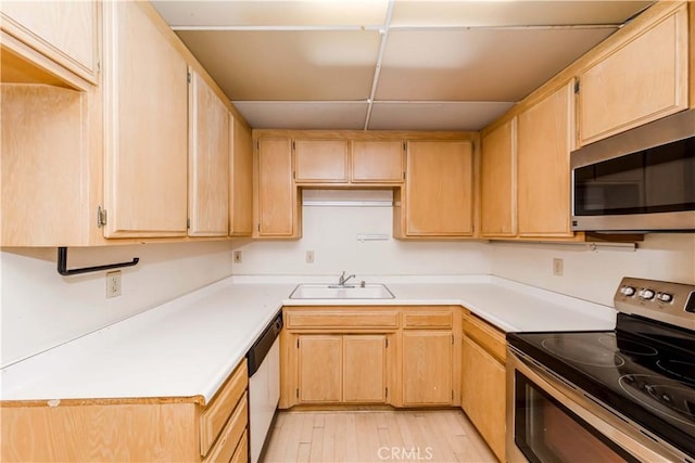 kitchen featuring appliances with stainless steel finishes, sink, light hardwood / wood-style flooring, and light brown cabinets