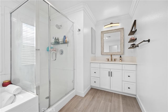 bathroom featuring an enclosed shower, hardwood / wood-style floors, vanity, and ornamental molding