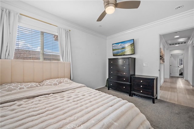 carpeted bedroom with crown molding and ceiling fan