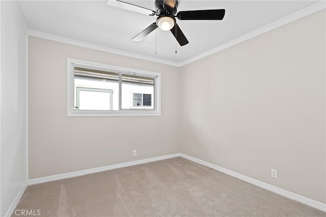 spare room with ceiling fan, light colored carpet, and ornamental molding