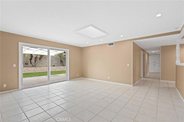 unfurnished room featuring light tile patterned floors and a skylight