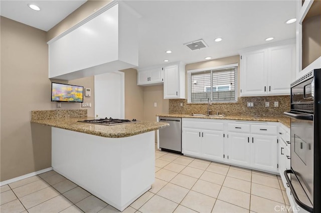 kitchen featuring white cabinetry, sink, stainless steel appliances, and kitchen peninsula